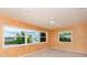 Bedroom showcasing large windows with a view to the lake and updated ceiling fan at 1816 N Pebble Beach Blvd, Sun City Center, FL 33573