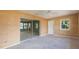 Bedroom featuring updated ceiling fan and large sliding glass doors to the lanai at 1816 N Pebble Beach Blvd, Sun City Center, FL 33573