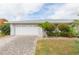 Charming home featuring a two-car garage, brick driveway, and verdant front yard at 1816 N Pebble Beach Blvd, Sun City Center, FL 33573