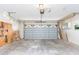 Spacious garage with a steel garage door offers parking and extra storage space at 1816 N Pebble Beach Blvd, Sun City Center, FL 33573