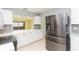 Open kitchen with stainless steel refrigerator, breakfast bar, and modern appliances at 1816 N Pebble Beach Blvd, Sun City Center, FL 33573