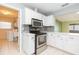 Bright kitchen with white cabinets, stainless steel appliances, and tiled flooring at 1816 N Pebble Beach Blvd, Sun City Center, FL 33573