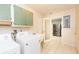 Laundry room with sink, washing machine, dryer, and updated cabinets at 1816 N Pebble Beach Blvd, Sun City Center, FL 33573