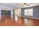 Spacious living room featuring a ceiling fan, window, and large mirrored closet doors at 1816 N Pebble Beach Blvd, Sun City Center, FL 33573