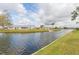 Waterfront homes featuring green lawns and access to canals under a cloudy sky at 1816 N Pebble Beach Blvd, Sun City Center, FL 33573