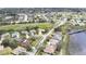 Aerial view of the home with a golf course and lake in the background at 18951 Grand Club Dr, Hudson, FL 34667