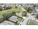 Aerial view of the property showcasing a scenic golf course and mature tree coverage at 18951 Grand Club Dr, Hudson, FL 34667