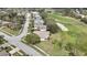 Aerial view of a home featuring a golf course view and mature tree coverage at 18951 Grand Club Dr, Hudson, FL 34667