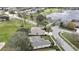 An aerial view of the property featuring a golf course view and mature tree coverage at 18951 Grand Club Dr, Hudson, FL 34667
