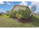 The home's backyard features carefully manicured beds and a spacious lawn at 18951 Grand Club Dr, Hudson, FL 34667