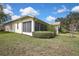 Backyard view of home featuring privacy landscaping and an enclosed lanai at 18951 Grand Club Dr, Hudson, FL 34667