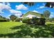 Lush backyard with mature trees, shrubbery, and manicured lawn at 18951 Grand Club Dr, Hudson, FL 34667