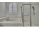 Clean bathroom with a shower and separate bathtub at 18951 Grand Club Dr, Hudson, FL 34667