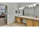 Bathroom featuring a large vanity with dual sinks and entry to the main bedroom at 18951 Grand Club Dr, Hudson, FL 34667