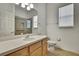 Well-lit bathroom with wood vanity, neutral countertop, and walk-in shower at 18951 Grand Club Dr, Hudson, FL 34667