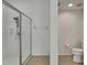 Bright bathroom featuring a glass enclosed shower and neutral tile flooring at 18951 Grand Club Dr, Hudson, FL 34667
