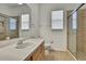 Clean bathroom featuring a wood vanity, large mirror, and glass-enclosed shower at 18951 Grand Club Dr, Hudson, FL 34667