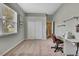 Neutral bedroom with carpet, closet, and a desk with a sewing machine at 18951 Grand Club Dr, Hudson, FL 34667