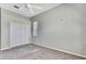 Bedroom with gray walls, neutral carpeting, ceiling fan, closet, and natural light at 18951 Grand Club Dr, Hudson, FL 34667