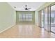 Bright bedroom features tile floors, a large window with shutters, and sliding door access to the lanai at 18951 Grand Club Dr, Hudson, FL 34667