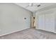 Bedroom with gray walls, neutral carpeting, closet, and natural light at 18951 Grand Club Dr, Hudson, FL 34667