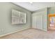 Bedroom with gray walls, neutral carpeting, and natural light at 18951 Grand Club Dr, Hudson, FL 34667