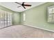 Bright bedroom with neutral carpet, crown molding, and plantation shutters providing privacy and elegance at 18951 Grand Club Dr, Hudson, FL 34667