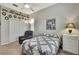 Bedroom showcases a ceiling fan, closet, and a decorative arrangement of Gathering photos above at 18951 Grand Club Dr, Hudson, FL 34667