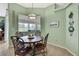 Cozy breakfast nook featuring a round table, wrought iron chairs, and views to the outside at 18951 Grand Club Dr, Hudson, FL 34667