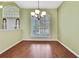 Bright dining room with a large window, plantation shutters and stylish chandelier at 18951 Grand Club Dr, Hudson, FL 34667