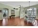 Bright dining room featuring wood floors, large windows and a stylish chandelier at 18951 Grand Club Dr, Hudson, FL 34667