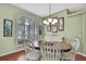 Inviting dining room with a wooden table, shutters, chandelier and light green walls at 18951 Grand Club Dr, Hudson, FL 34667