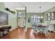 Elegant dining room with hardwood floors, stylish lighting, and a view of the home's entryway at 18951 Grand Club Dr, Hudson, FL 34667