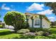 Close up of exterior of the home featuring manicured landscaping and charming architectural details at 18951 Grand Club Dr, Hudson, FL 34667