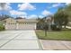 Attractive single-story home with a three-car garage, well-kept lawn, and pleasing curb appeal at 18951 Grand Club Dr, Hudson, FL 34667