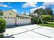 Well-maintained home with a three-car garage and neatly manicured landscaping at 18951 Grand Club Dr, Hudson, FL 34667