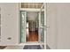 Welcoming entryway with a glass-paneled front door, complemented by a view of the interior and hardwood floors at 18951 Grand Club Dr, Hudson, FL 34667