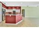 Kitchen with stainless steel appliances, island with bar seating, granite countertops, and a view into the living area at 18951 Grand Club Dr, Hudson, FL 34667