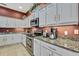 Close up of the modern kitchen featuring granite countertops, stainless steel appliances, and cabinet space at 18951 Grand Club Dr, Hudson, FL 34667