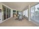 Inviting lanai with tile flooring, plenty of natural light, and comfortable seating arrangement at 18951 Grand Club Dr, Hudson, FL 34667