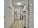 Laundry room with washer, dryer, and ample storage space and white appliances at 18951 Grand Club Dr, Hudson, FL 34667