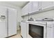 Bright laundry room with large capacity washer and dryer and side-by-side refrigerator at 18951 Grand Club Dr, Hudson, FL 34667