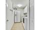 Laundry room with tile flooring, washer and dryer, storage cabinets, and refrigerator at 18951 Grand Club Dr, Hudson, FL 34667