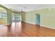 Spacious living room with sliding doors leading to the lanai and beautiful laminate flooring at 18951 Grand Club Dr, Hudson, FL 34667