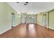 Bright living room with elegant archways, high ceilings, and gleaming laminate flooring at 18951 Grand Club Dr, Hudson, FL 34667