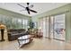 Inviting living room featuring a sliding glass door, tile flooring, and neutral decor at 18951 Grand Club Dr, Hudson, FL 34667