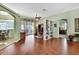 Open-concept living area with hardwood flooring, stylish built-in shelving, and a bright, airy feel at 18951 Grand Club Dr, Hudson, FL 34667