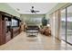 Spacious living room with tile flooring, large windows, and a comfortable seating arrangement at 18951 Grand Club Dr, Hudson, FL 34667