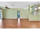 Large living room featuring laminate floors, high ceilings and an open concept layout at 18951 Grand Club Dr, Hudson, FL 34667