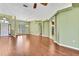 Spacious living area with hardwood floors, arched entryways, and a large window allowing for ample natural light at 18951 Grand Club Dr, Hudson, FL 34667